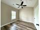 Bedroom with high ceilings, ceiling fan, window, and vinyl flooring at 8668 Coralbell Ln # 10, Charlotte, NC 28213