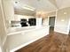 A kitchen featuring white cabinets, modern appliances, and a breakfast bar for casual dining at 8668 Coralbell Ln # 10, Charlotte, NC 28213