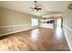 Bright, open floor plan living area with neutral paint colors and wood-look laminate flooring at 8668 Coralbell Ln # 10, Charlotte, NC 28213