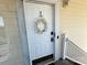 Charming front door with wreath, address number, and modern lock at 8668 Coralbell Ln # 10, Charlotte, NC 28213