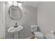 Well-lit half bathroom featuring a pedestal sink and toilet at 9014 Arbor Creek Dr, Charlotte, NC 28269