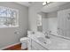 Bright bathroom with modern fixtures, a large mirror, and a window for natural light at 9014 Arbor Creek Dr, Charlotte, NC 28269