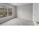 Clean, carpeted bedroom with a large window offering a view to the outdoors at 9014 Arbor Creek Dr, Charlotte, NC 28269