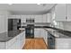 Bright kitchen with an island, granite counters, and sleek black appliances at 9014 Arbor Creek Dr, Charlotte, NC 28269