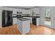 Well-lit kitchen with granite countertops, white cabinets, and modern black appliances at 9014 Arbor Creek Dr, Charlotte, NC 28269