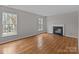 Bright living room showcasing hardwood floors, fireplace, and ample natural light at 9014 Arbor Creek Dr, Charlotte, NC 28269