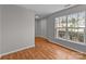 Hardwood floors, neutral walls, and a bright window feature in this open living space at 9014 Arbor Creek Dr, Charlotte, NC 28269