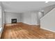 Spacious living room featuring hardwood floors and cozy fireplace at 9014 Arbor Creek Dr, Charlotte, NC 28269