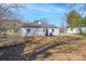 Backyard view of a white house with vinyl siding and ample green space at 910 Mcdow Dr, Rock Hill, SC 29732