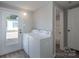 Convenient laundry room featuring a washer, dryer, and access to the backyard at 910 Mcdow Dr, Rock Hill, SC 29732