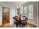 Cozy dining room featuring a wood table, elegant lighting, and large windows offering ample natural light at 957 Hathcock Glen Dr, Oakboro, NC 28129