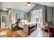 Elegant main bedroom showcasing serene colors, wainscoting, hardwood floors, and large windows at 957 Hathcock Glen Dr, Oakboro, NC 28129