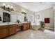 Bathroom with dual sink vanity and a large soaking tub at 10620 S Ford Rd, Charlotte, NC 28214
