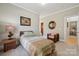 Bedroom with a comfy bed, side table, and view of the bathroom area at 10620 S Ford Rd, Charlotte, NC 28214