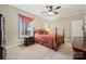 Comfortable bedroom featuring a four poster bed, neutral walls and a ceiling fan at 10620 S Ford Rd, Charlotte, NC 28214