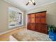 Bright bedroom featuring hardwood floors, and a large storage cabinet for ample storage at 10620 S Ford Rd, Charlotte, NC 28214