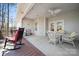 Spacious covered patio with wicker seating, ceiling fan and view of the surrounding landscape at 10620 S Ford Rd, Charlotte, NC 28214