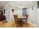 Charming dining area with a round table and views of the backyard and living room at 10620 S Ford Rd, Charlotte, NC 28214