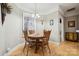 Charming dining area with hardwood floors, a round wooden table, and natural light at 10620 S Ford Rd, Charlotte, NC 28214