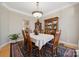 Formal dining room with hardwood floors, elegant china cabinet, and decorative chandelier at 10620 S Ford Rd, Charlotte, NC 28214