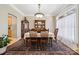 Bright dining room featuring hardwood floors, elegant china cabinet, and a large window at 10620 S Ford Rd, Charlotte, NC 28214