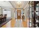 Grand foyer with hardwood floors, a decorative chandelier, and lots of natural light at 10620 S Ford Rd, Charlotte, NC 28214