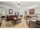 Cozy living room features a ceiling fan, hardwood floors, and comfortable seating arrangements at 10620 S Ford Rd, Charlotte, NC 28214