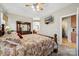 View of the primary bedroom showcasing a comfortable bed and view to the primary bath at 10620 S Ford Rd, Charlotte, NC 28214