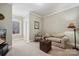 Cozy sitting room with tan sofa, rocking chair, natural light, and neutral paint at 10620 S Ford Rd, Charlotte, NC 28214