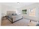 Bright bedroom with large windows and a beautifully upholstered bed at 108 Berkshire Ave, Belmont, NC 28012