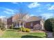 Charming brick home with a well-manicured lawn, beautiful landscaping and a welcoming front porch at 108 Berkshire Ave, Belmont, NC 28012