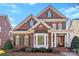 Charming two-story brick home featuring a covered front porch and manicured landscaping at 108 Berkshire Ave, Belmont, NC 28012