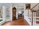 Foyer featuring hardwood floors, a grandfather clock, and an open view to an office space at 108 Berkshire Ave, Belmont, NC 28012