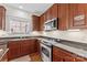 Modern kitchen with stainless steel appliances, granite countertops, and wooden cabinets at 108 Berkshire Ave, Belmont, NC 28012