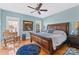 Stylish main bedroom features a large bed, hardwood floors, and ceiling fan at 108 Berkshire Ave, Belmont, NC 28012