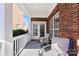 Cozy front porch seating area with two chairs and a brick exterior wall at 108 Berkshire Ave, Belmont, NC 28012