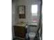 Bathroom with a corner sink, toilet, medicine cabinet, and a small window at 111 Scenic Ln, New London, NC 28127