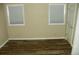 This bedroom features wood-look floors, tan walls, and a door on the right side at 111 Scenic Ln, New London, NC 28127