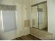 A cozy bedroom with built-in storage, closet with mirrored sliding doors and laminate flooring at 111 Scenic Ln, New London, NC 28127