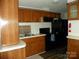 The kitchen features wooden cabinets, black appliances, and a laminate countertop at 111 Scenic Ln, New London, NC 28127