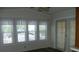 The sunroom features multiple windows with blinds for optimal privacy at 111 Scenic Ln, New London, NC 28127