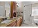 Bright bathroom featuring double vanities, a glass enclosed shower and neutral color palette at 11280 Mcfalls Dr, Fort Mill, SC 29707