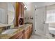 This bathroom features a double vanity with granite countertops and a luxurious glass-enclosed shower at 11280 Mcfalls Dr, Fort Mill, SC 29707