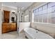 Elegant bathroom featuring a clawfoot tub, glass shower, and custom vanity with granite countertop at 11280 Mcfalls Dr, Fort Mill, SC 29707