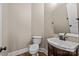 Powder room showcasing a floating sink, dark wood vanity, round mirror and wood flooring at 11280 Mcfalls Dr, Fort Mill, SC 29707