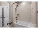 Bathroom with a soaking tub, tiled walls, and matte black hardware fixtures for a modern aesthetic at 11280 Mcfalls Dr, Fort Mill, SC 29707