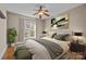 Bright bedroom featuring a ceiling fan, neutral walls, stylish furnishings, and a window with natural light at 11280 Mcfalls Dr, Fort Mill, SC 29707