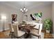 Cozy dining room showcasing a table set for six, modern chandelier, abstract art, and plant at 11280 Mcfalls Dr, Fort Mill, SC 29707