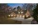 Charming home featuring a three-car garage, stone accents, and a well-maintained lawn surrounded by mature trees at 11280 Mcfalls Dr, Fort Mill, SC 29707