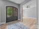 Elegant foyer featuring double doors, hardwood floors, a stylish rug, and a glimpse of an open, airy room at 11280 Mcfalls Dr, Fort Mill, SC 29707